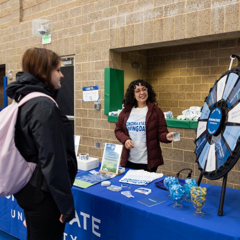Student spinning a prize wheel