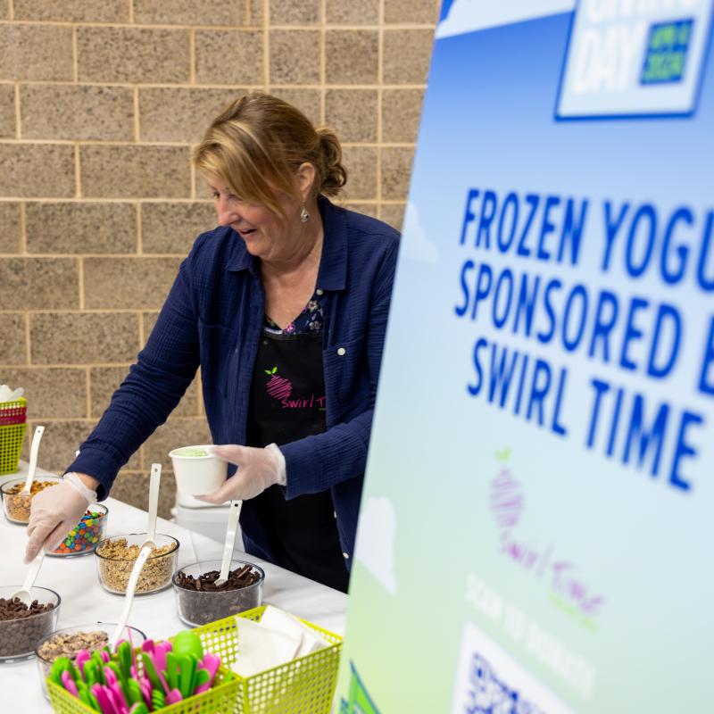 Person grabbing toppings for frozen yogurt